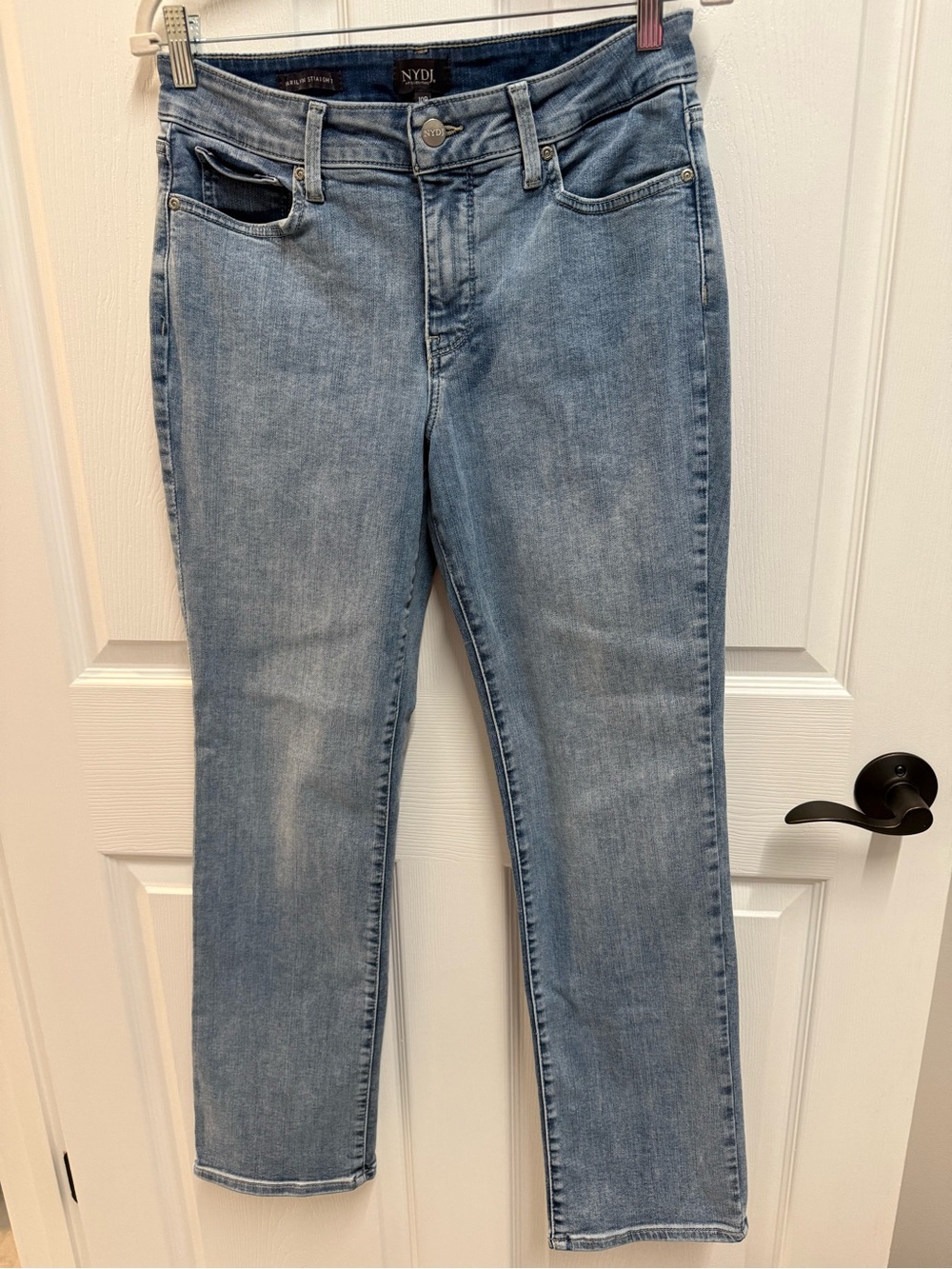 NYDJ (Not Your Daughter's Jeans) light wash straight-leg denim jeans.
